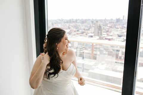 bride laughing in window